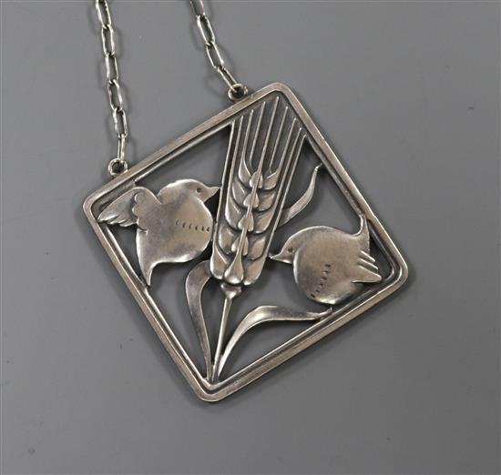 A Danish Georg Jensen sterling silver square pendant, depicting two robins with a wheatsheaf, no. 93,